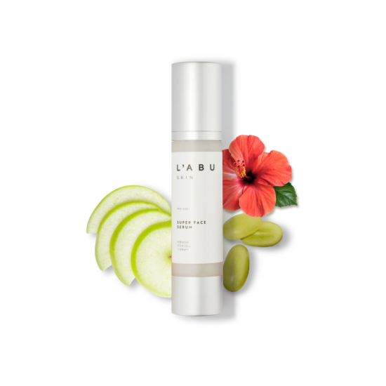 Age Pro+ Face Serum bottle surrounded by apple slices, grapes and flowers